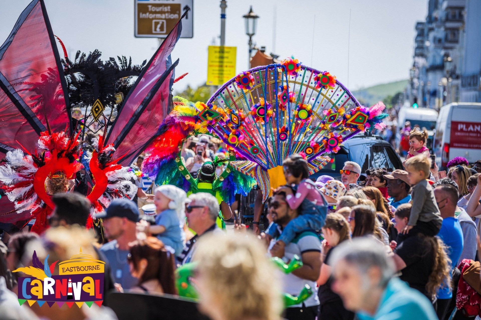 Eastbourne Carnival parade with colourful feathered costumes